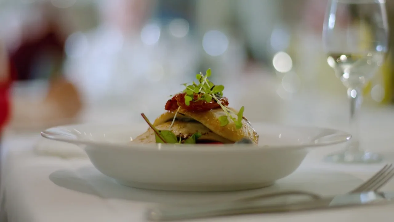 A plated fish course finished with micro herbs at a Basil Algarve private dinner